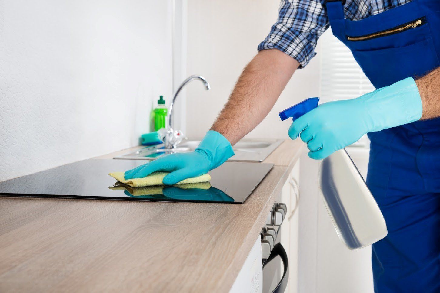 Cleaning Service — Worker Wiping a Tabletop in Atlanta, GA