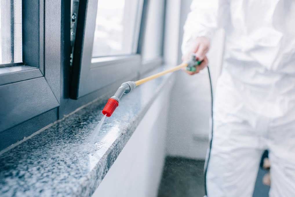 Spraying Some Cleaning Liquid — Atlanta, GA — Janitorial Services Atlanta