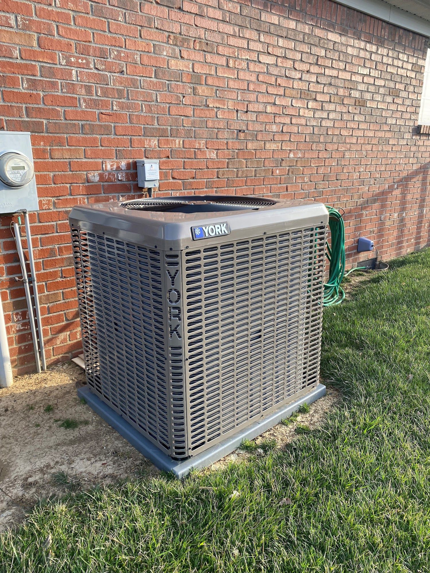 York air conditioner unit outside a brick building.