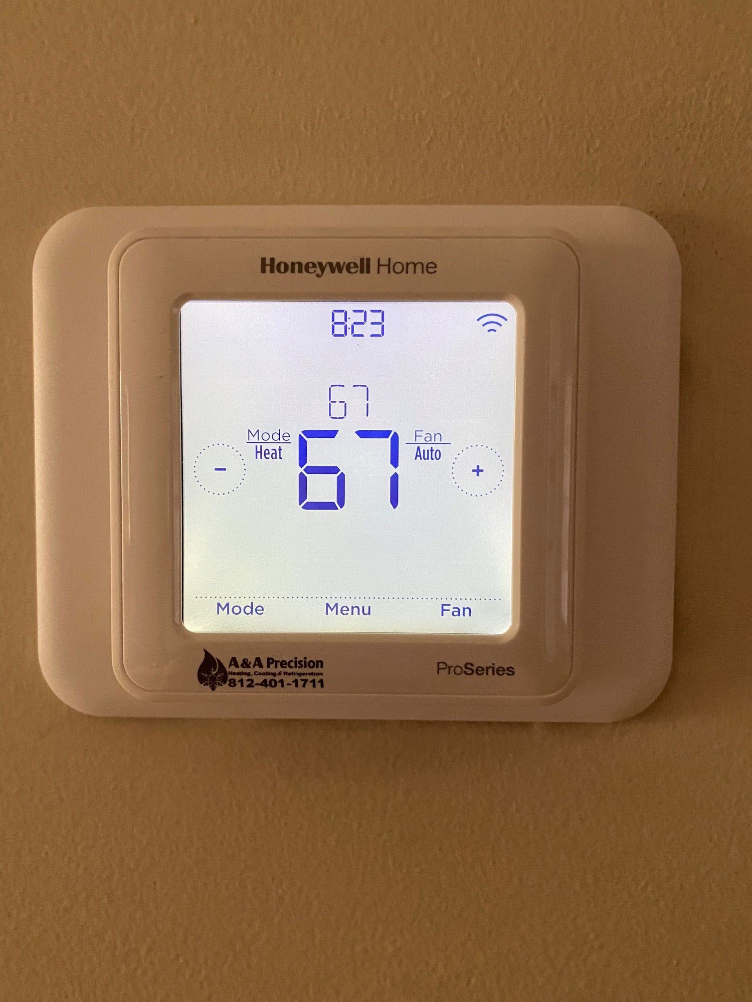 Honeywell Home thermostat displaying time 8:23, set temperature 67 degrees.