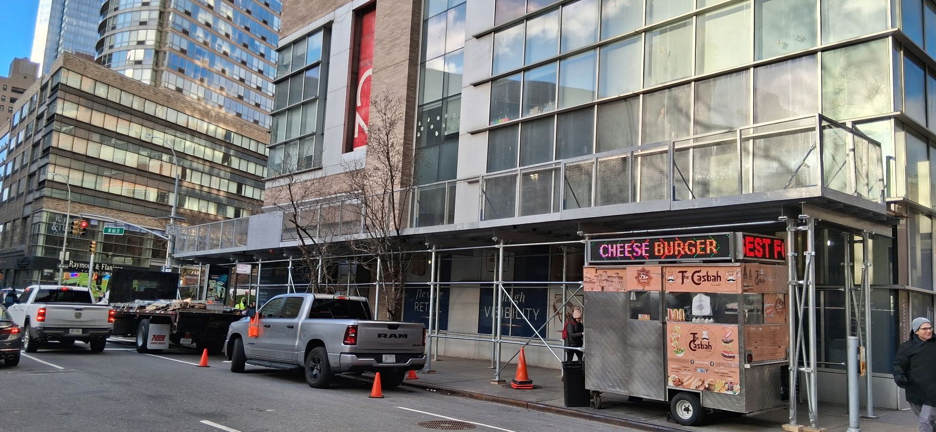 Yellow and silver mobile scaffolding on a city construction site.