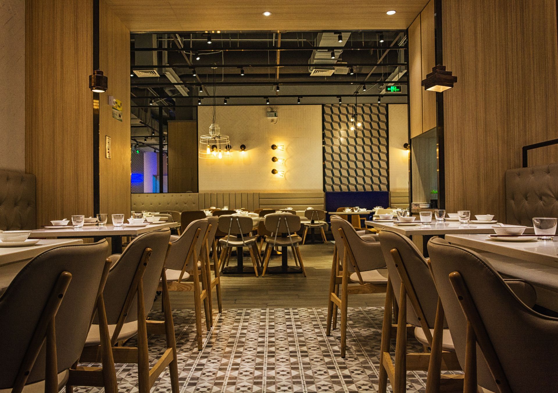 A restaurant with tables and chairs and a tiled floor.