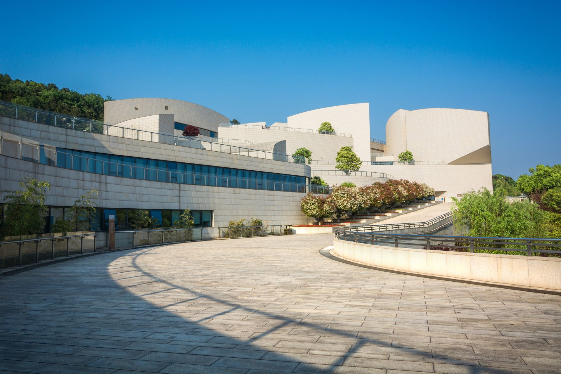 A large white building with a curved walkway in front of it.