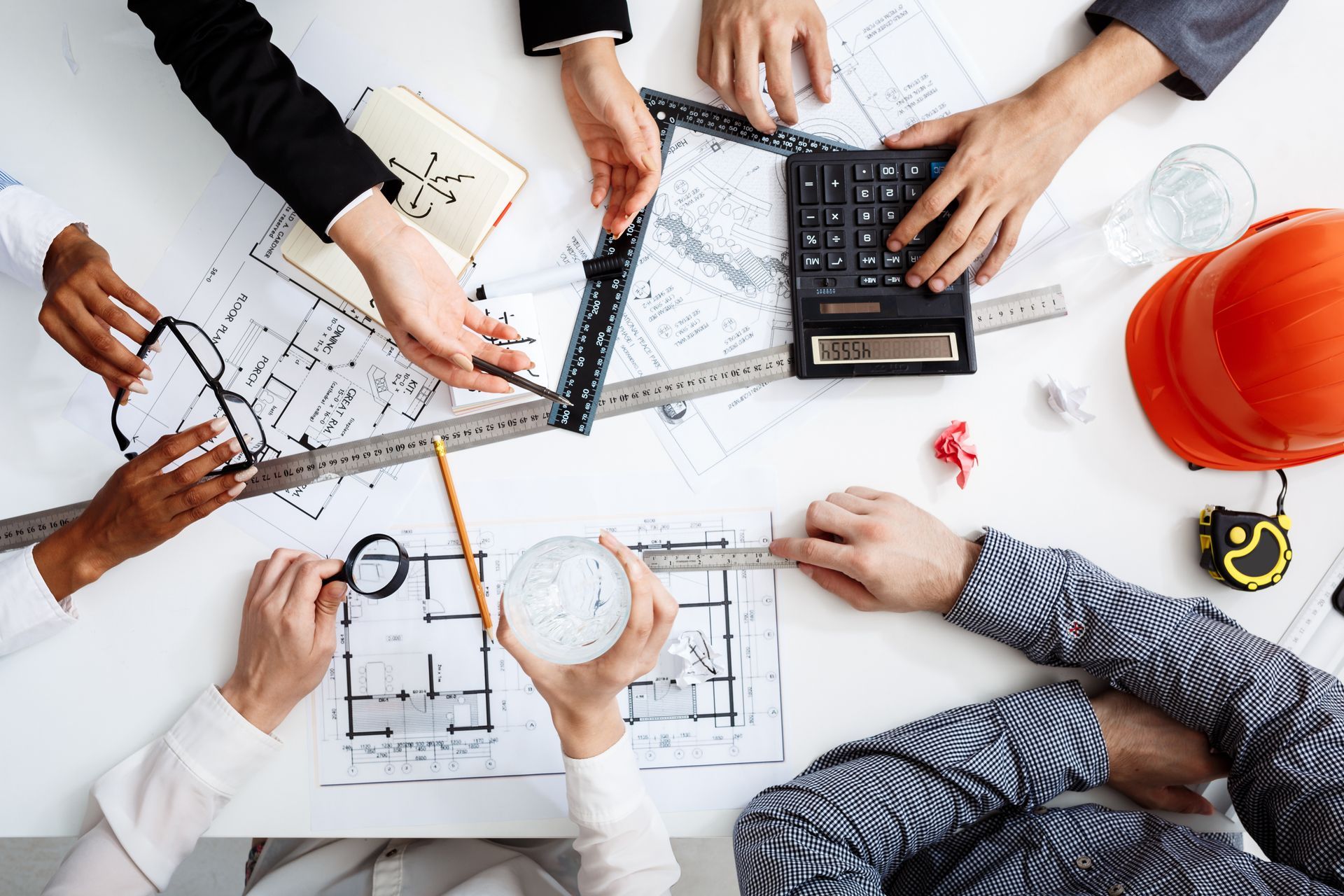 A group of people are sitting around a table working on a project.