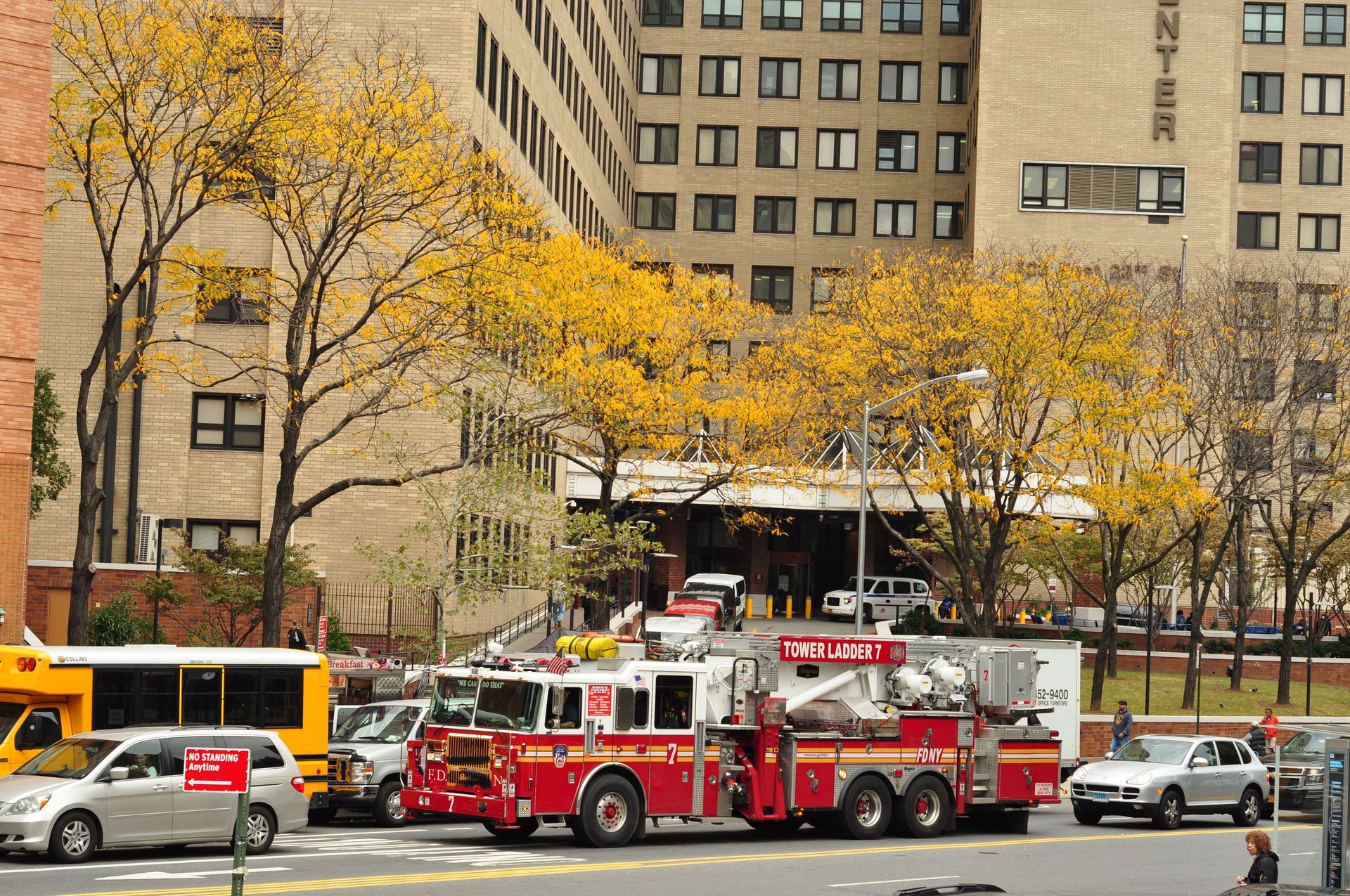 Several fire trucks are parked on the side of the road