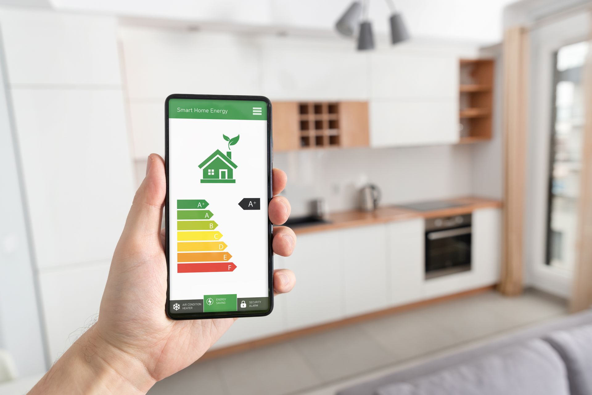 A person is holding a smart phone with an energy efficiency rating on the screen.