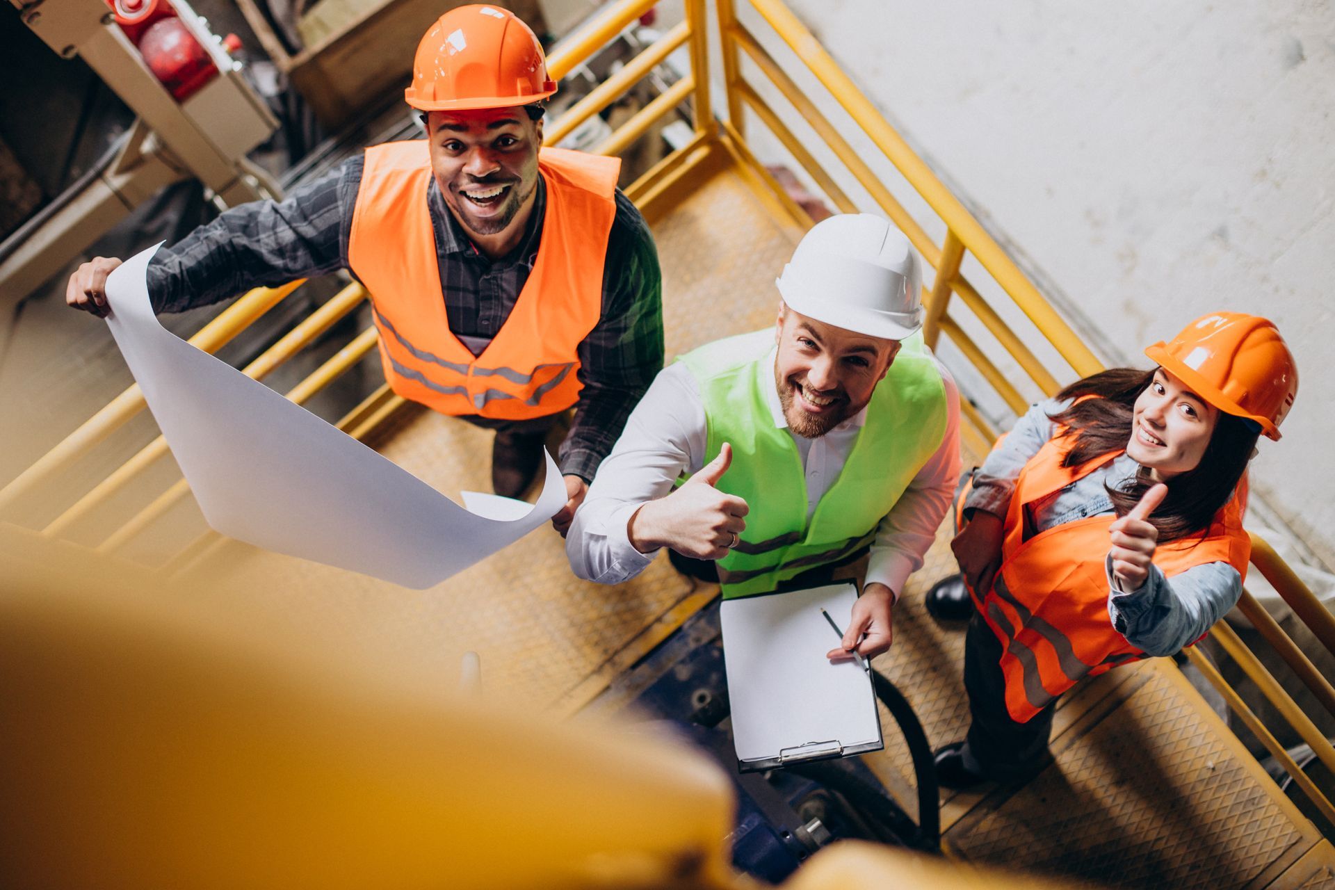 A group of construction workers are standing on a set of stairs.