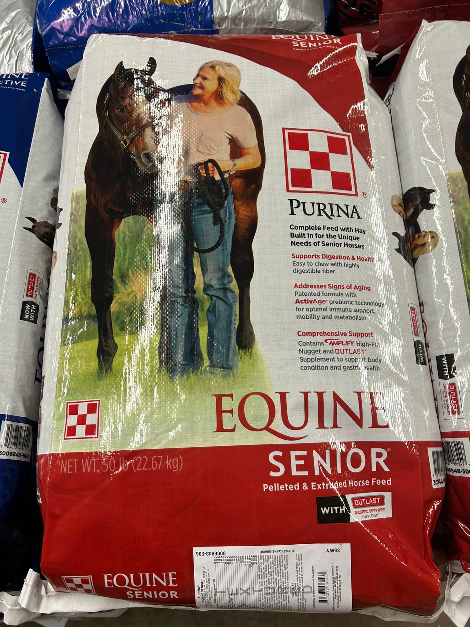 Purina Equine Senior horse feed bag with a person and horse, white, red, and brown colors.