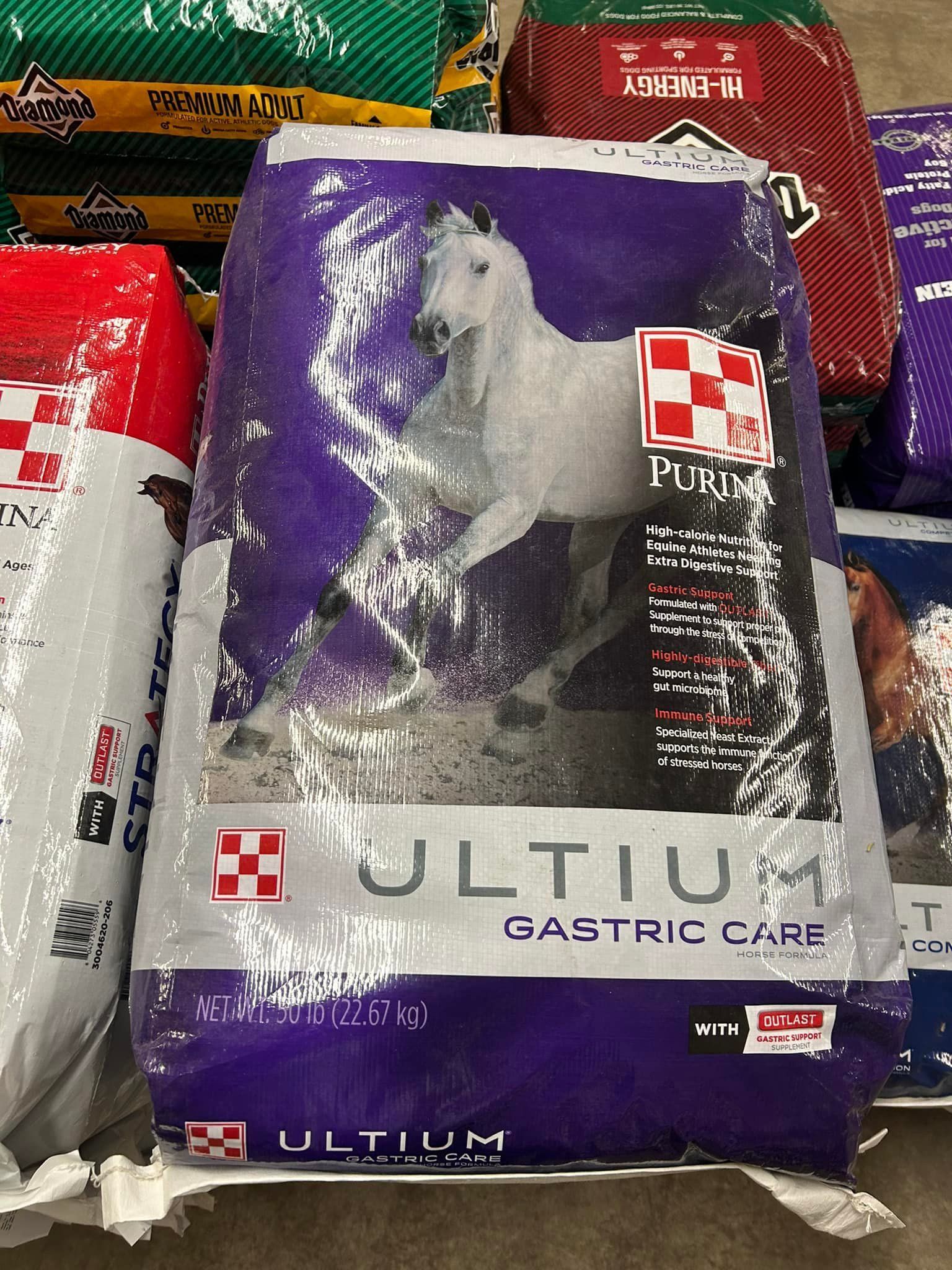 Bag of Purina Ultium Gastric Care horse feed with a white horse on a purple background.