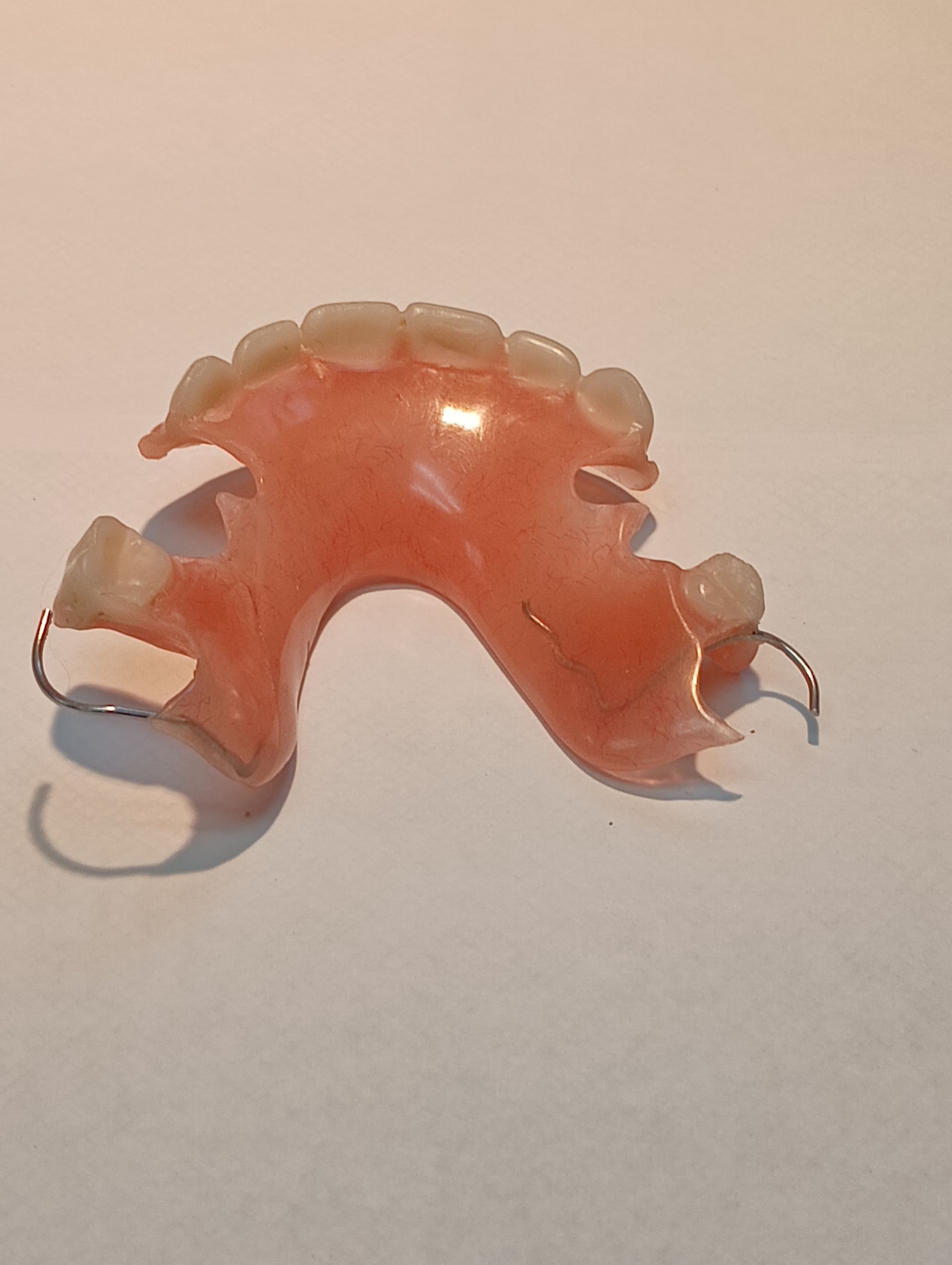 A dentist is working on a model of a person 's teeth.