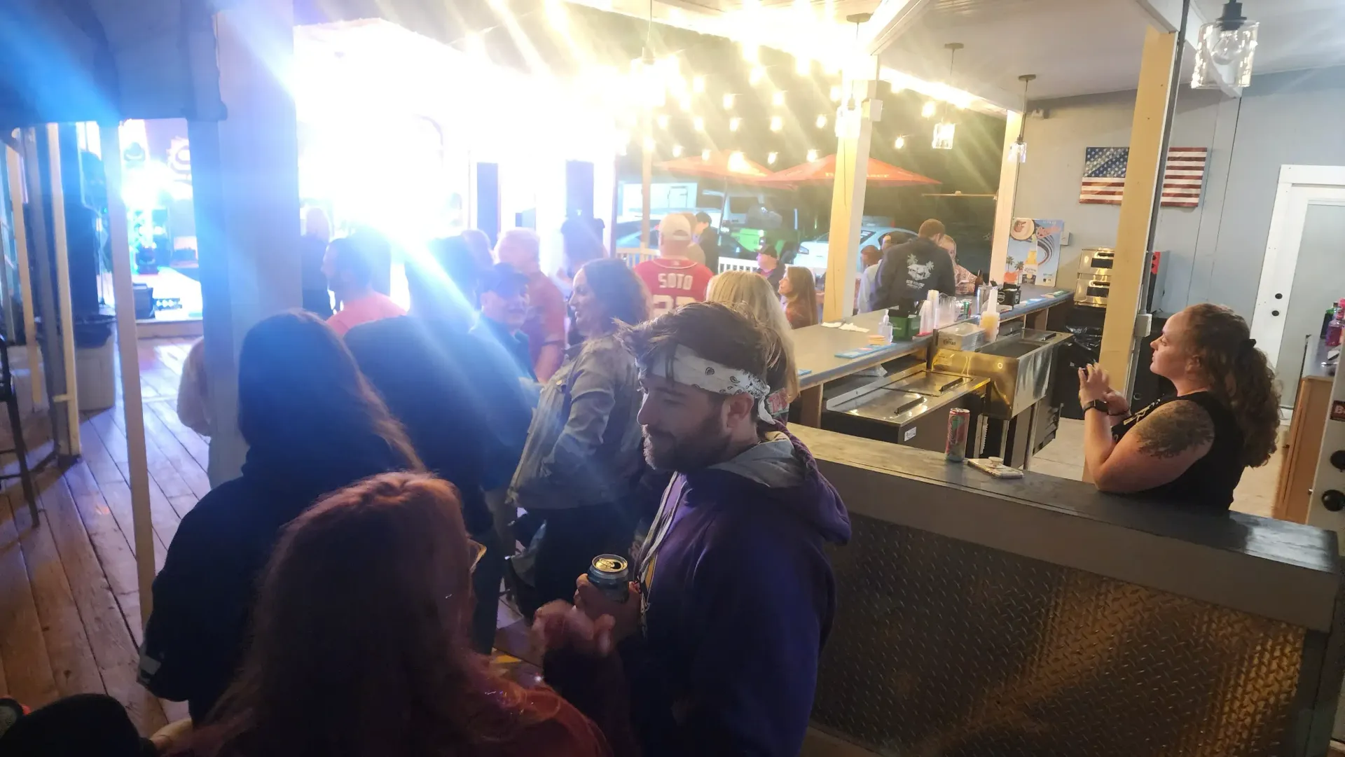 Bartender pouring drinks behind the full bar counter