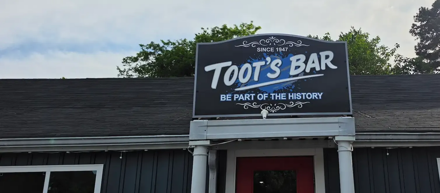 Exterior of Toot's Bar at dusk