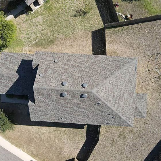 An aerial view of a house with a roof that has a lot of holes in it.