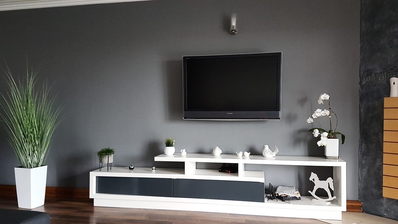 a living room with a flat screen tv on the wall