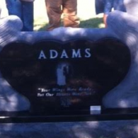 A black, heart-shaped gravestone with 