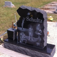 A black granite headstone with the name 