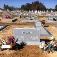 A gray granite headstone inscribed 
