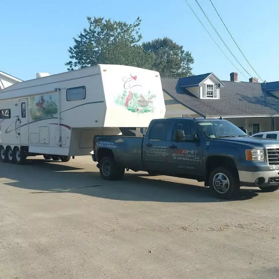 A truck is pulling a trailer that says lg on it