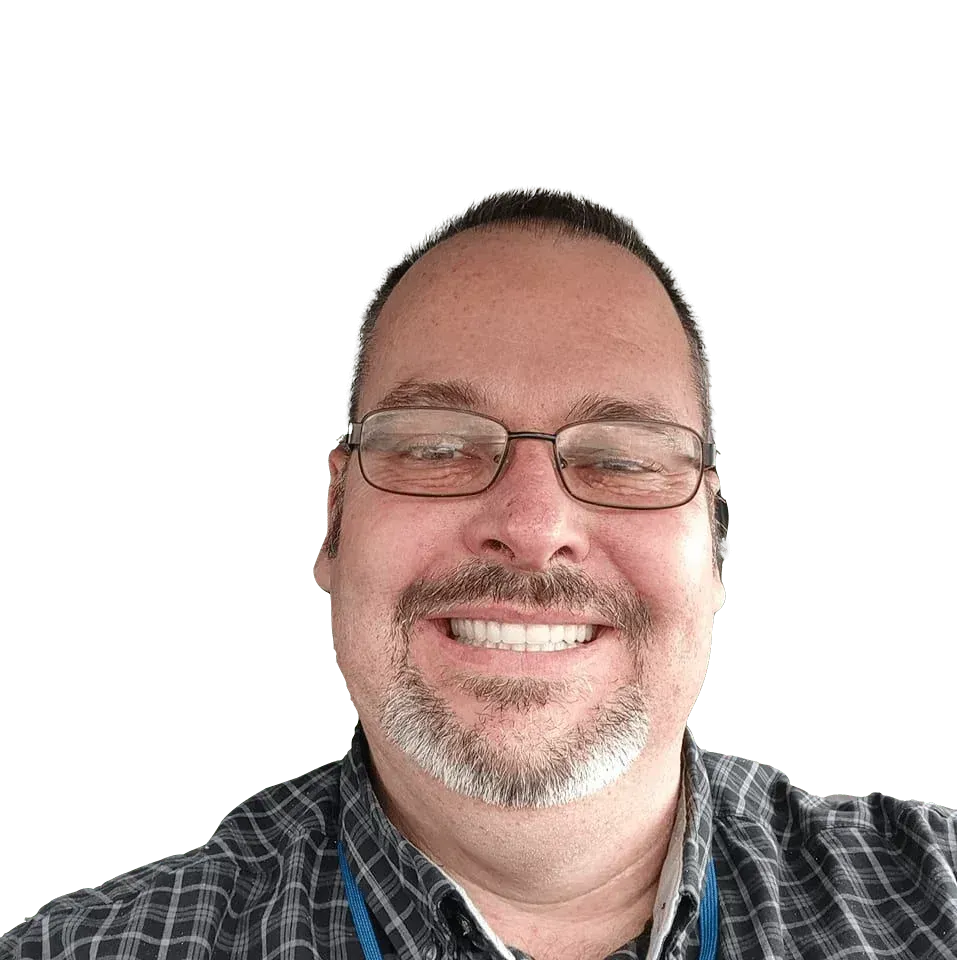 A man with glasses and a beard is smiling for the camera.