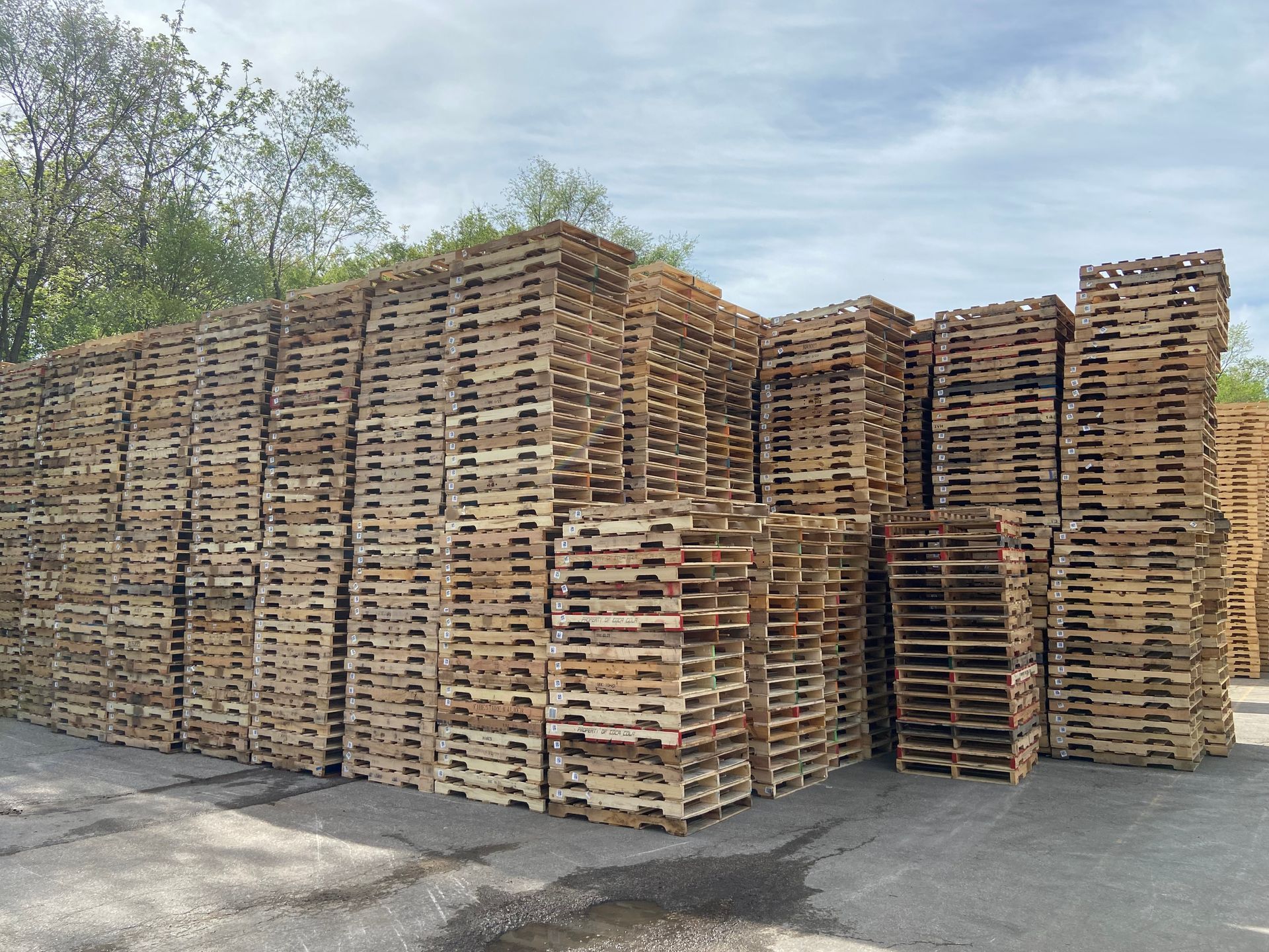 A large pile of wooden pallets stacked on top of each other