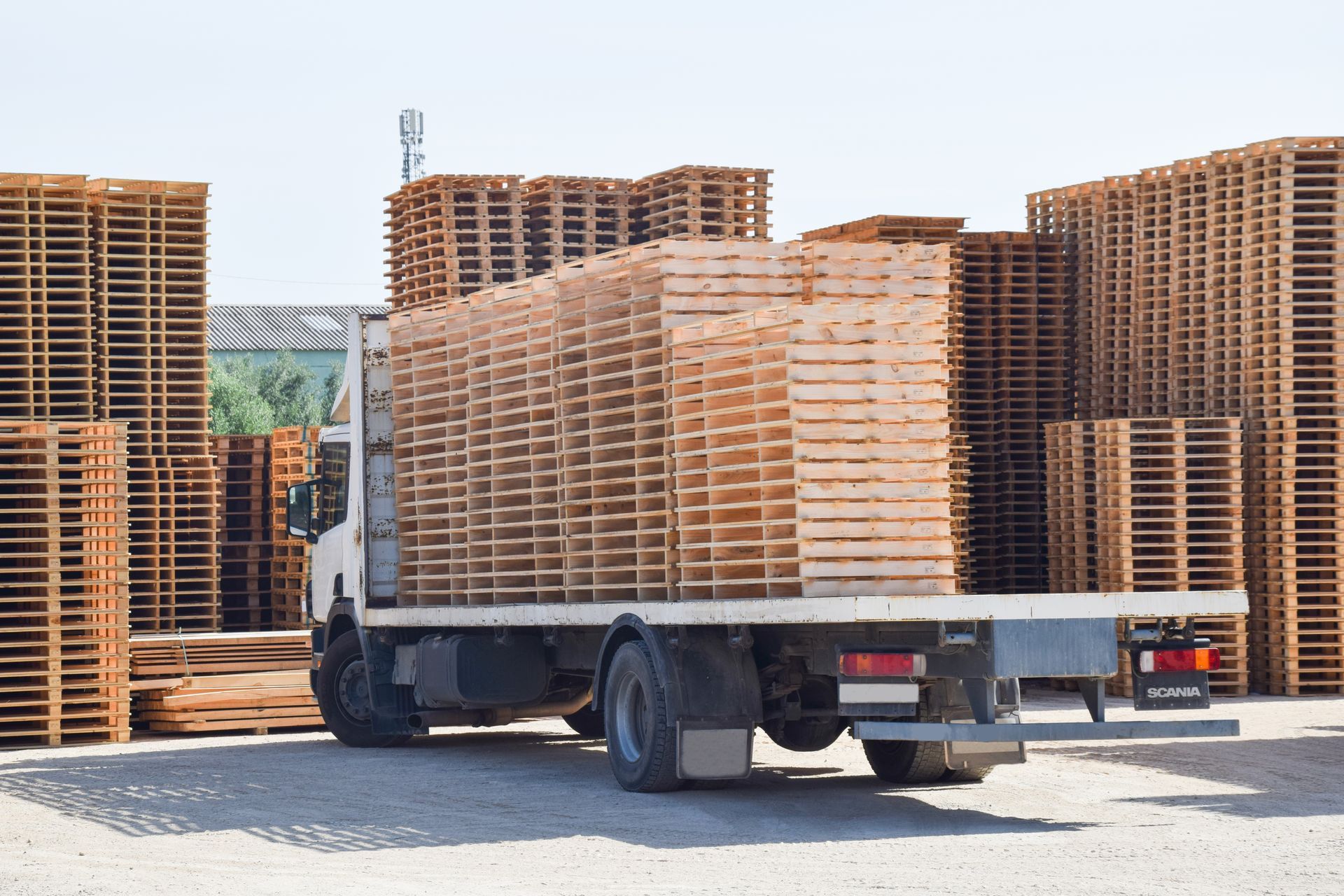 a truck is loaded with wooden heat treaded pallets in a warehouse