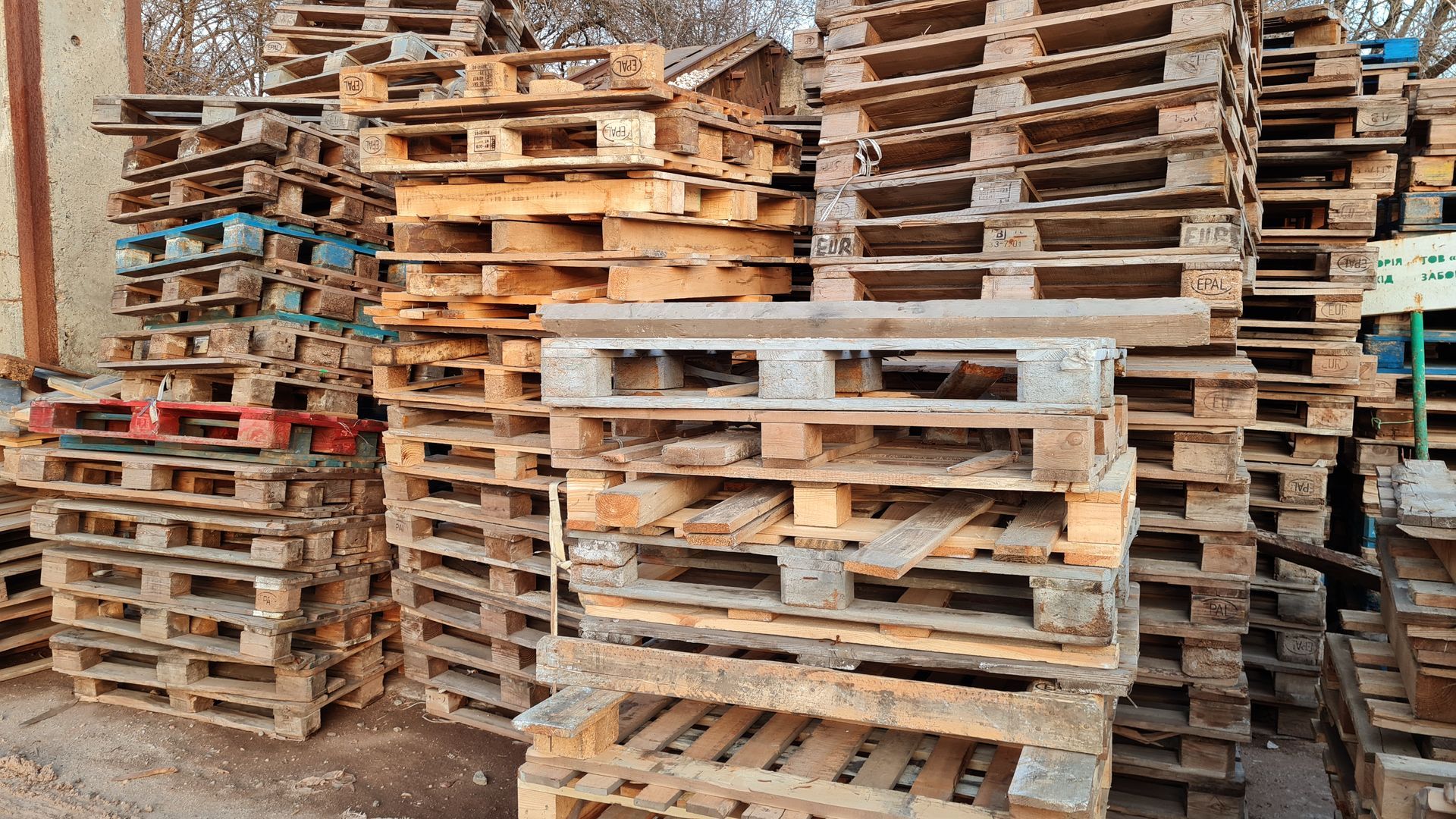 stacks of used pallets to be sold