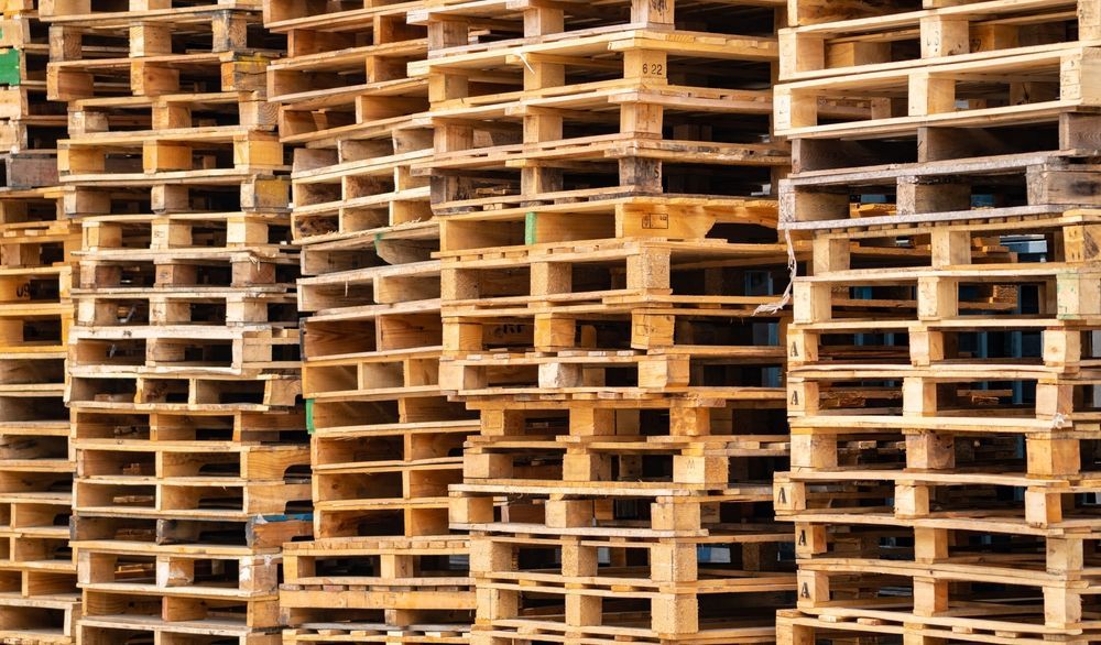 A pile of wooden pallets stacked on top of each other.