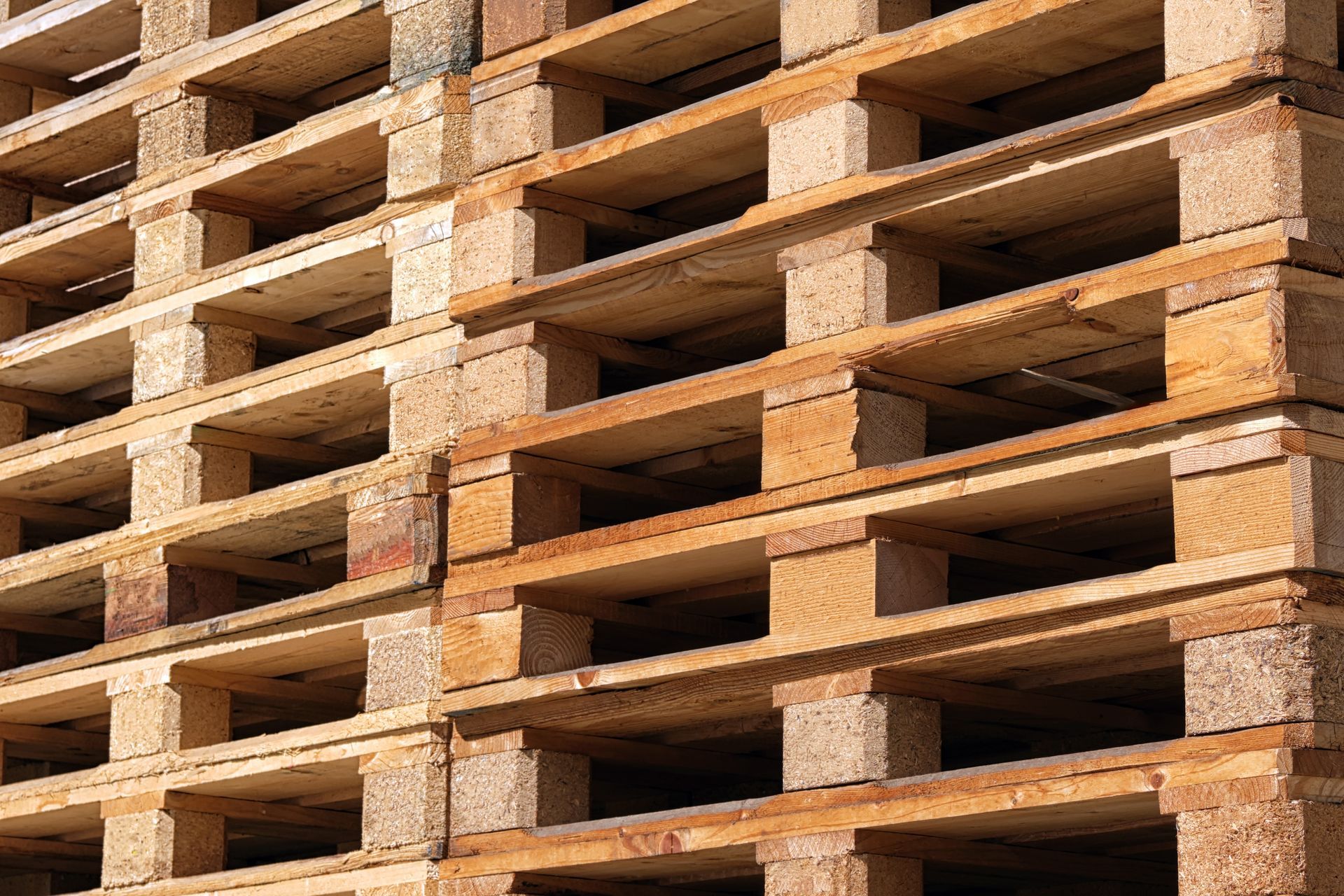 A bunch of wood pallets stacked on top of each other. 