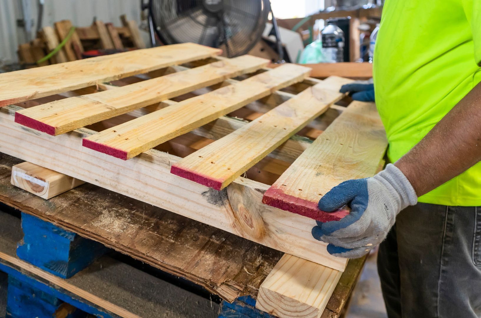 man repairing used pallet for sale