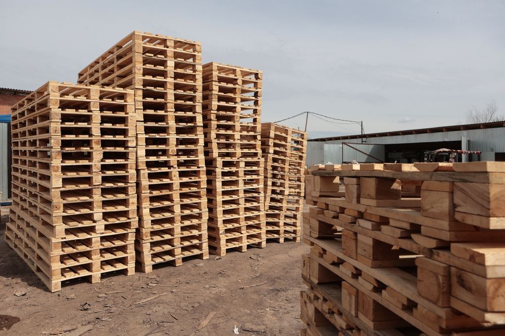 A bunch of wooden pallets are stacked on top of each other