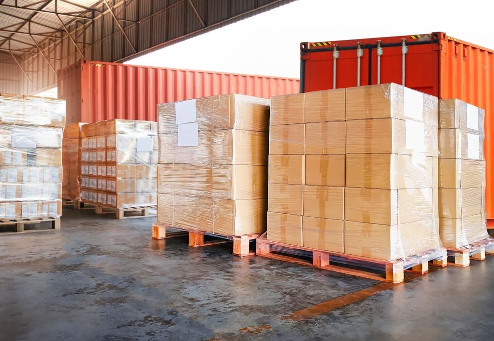 A warehouse filled with lots of boxes and pallets.