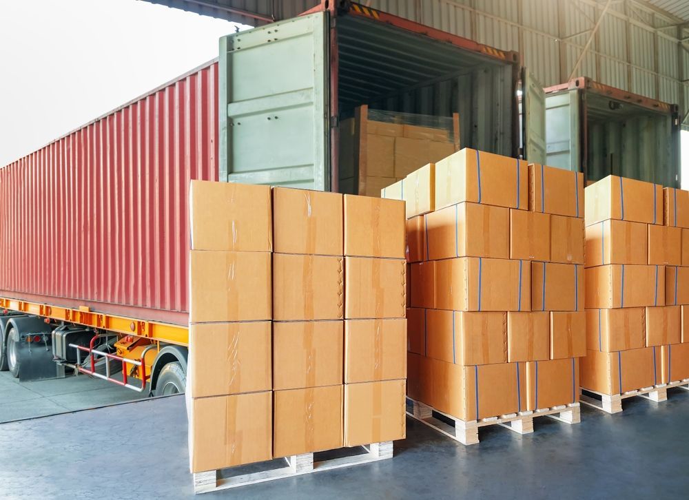 A truck is loaded with boxes and pallets in a warehouse.