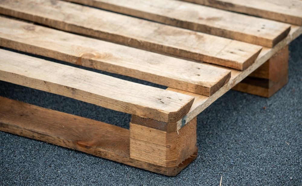 A wooden pallet is sitting on the ground.