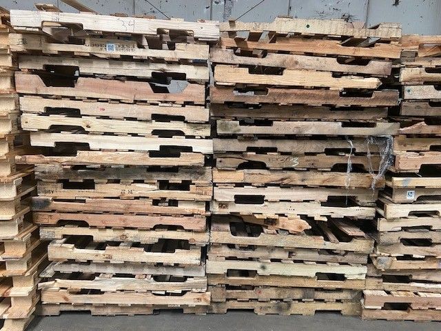 A pile of wooden pallets stacked on top of each other