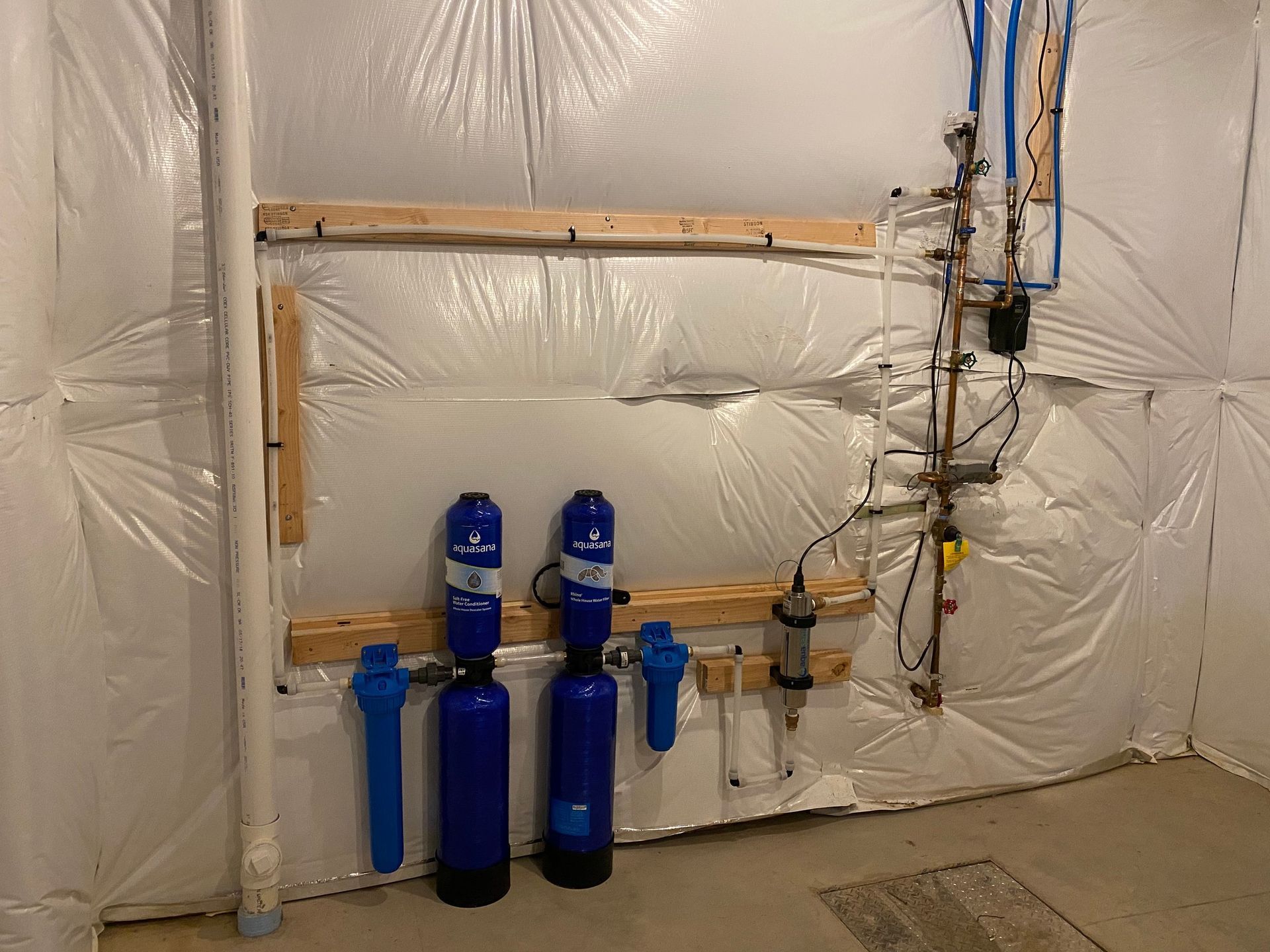 A couple of blue bottles are sitting on a wall in a room.