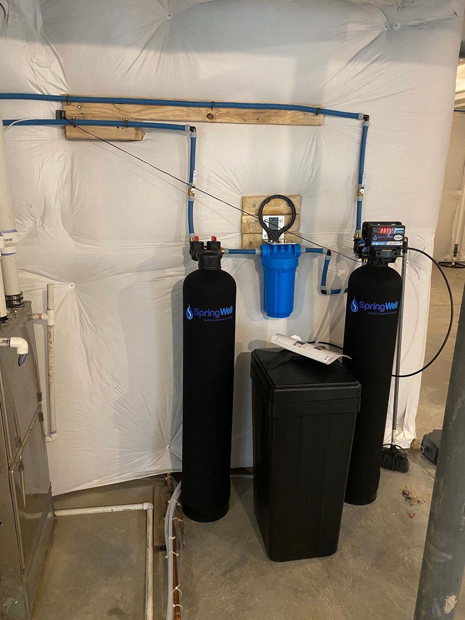 Two water filters are sitting next to each other in a room.
