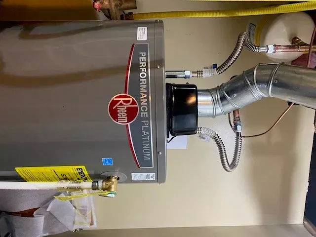 A rheem water heater is installed in a bathroom.