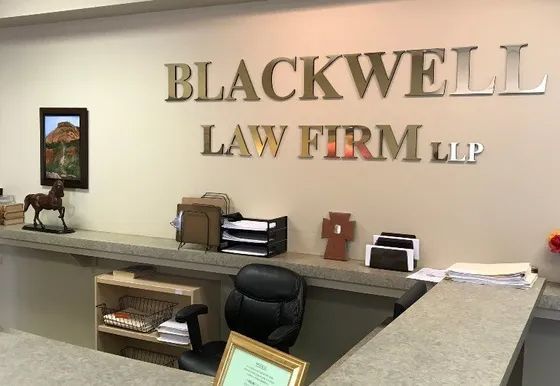 A sign for blackwell law firm llp is above a desk