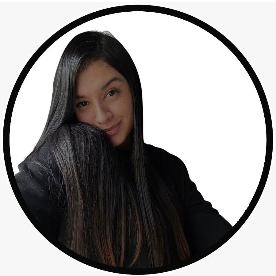 A young woman with long dark hair smiles and rests her head on her arm inside a black-bordered circle.