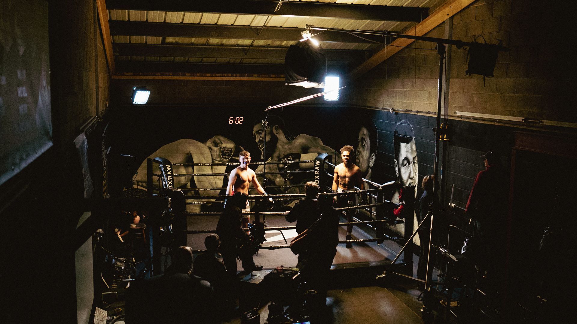 A group of people are standing in a dark room.