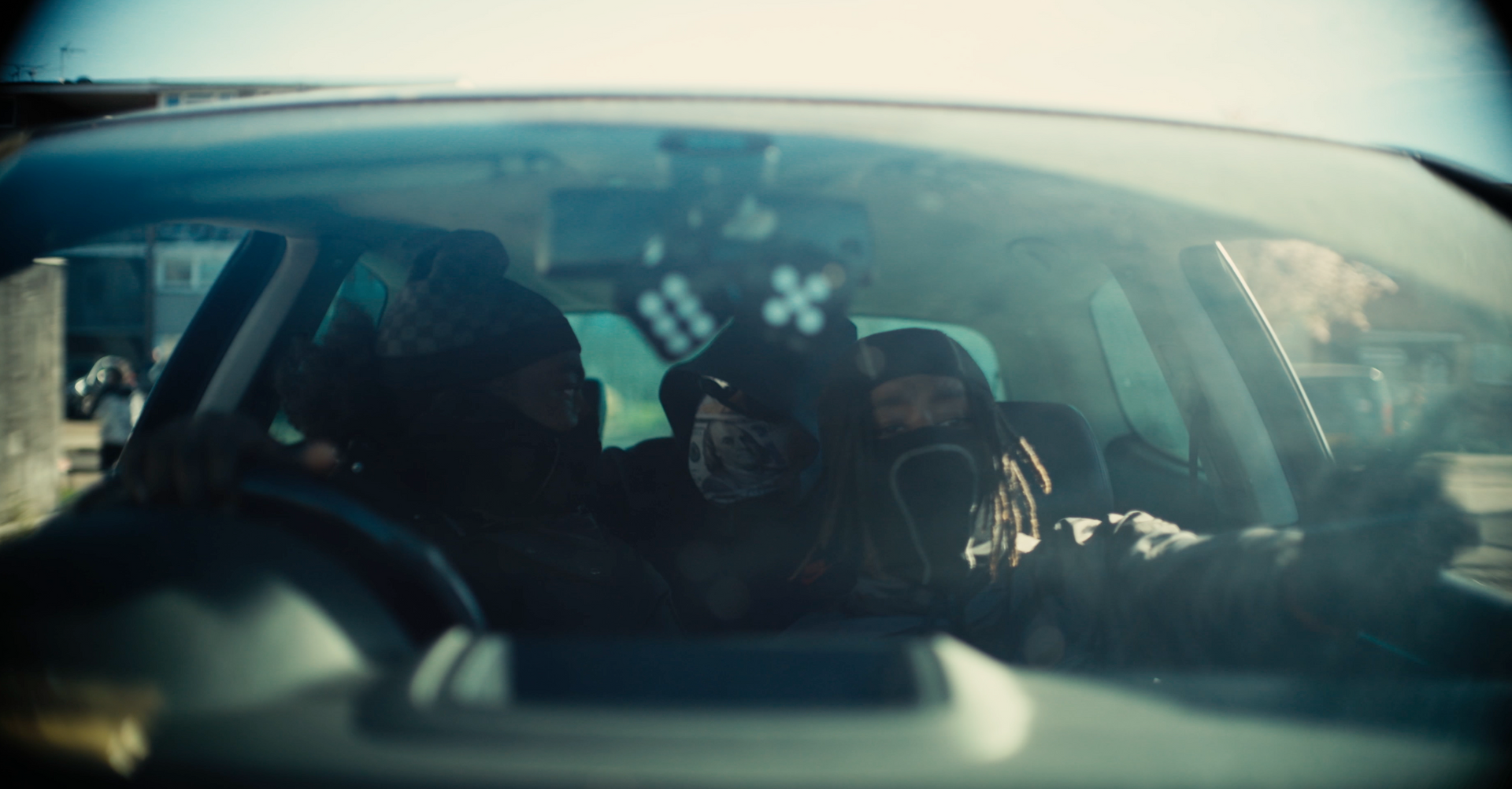 A man is sitting in the driver 's seat of a car.