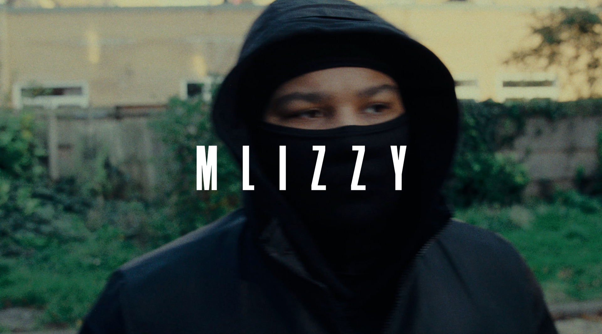 A man in a hooded jacket with a mask on his face.