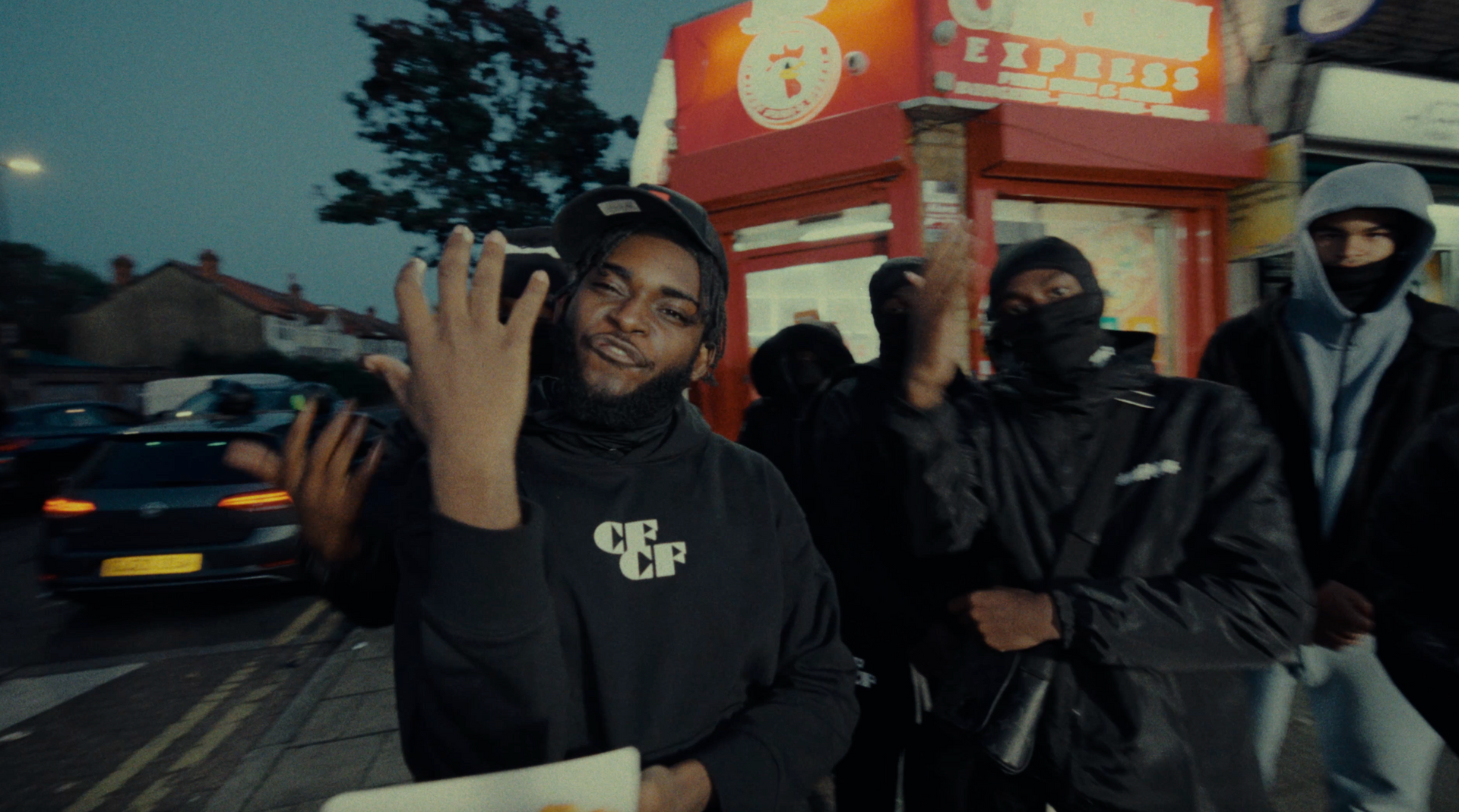 A group of men are standing in front of a restaurant.
