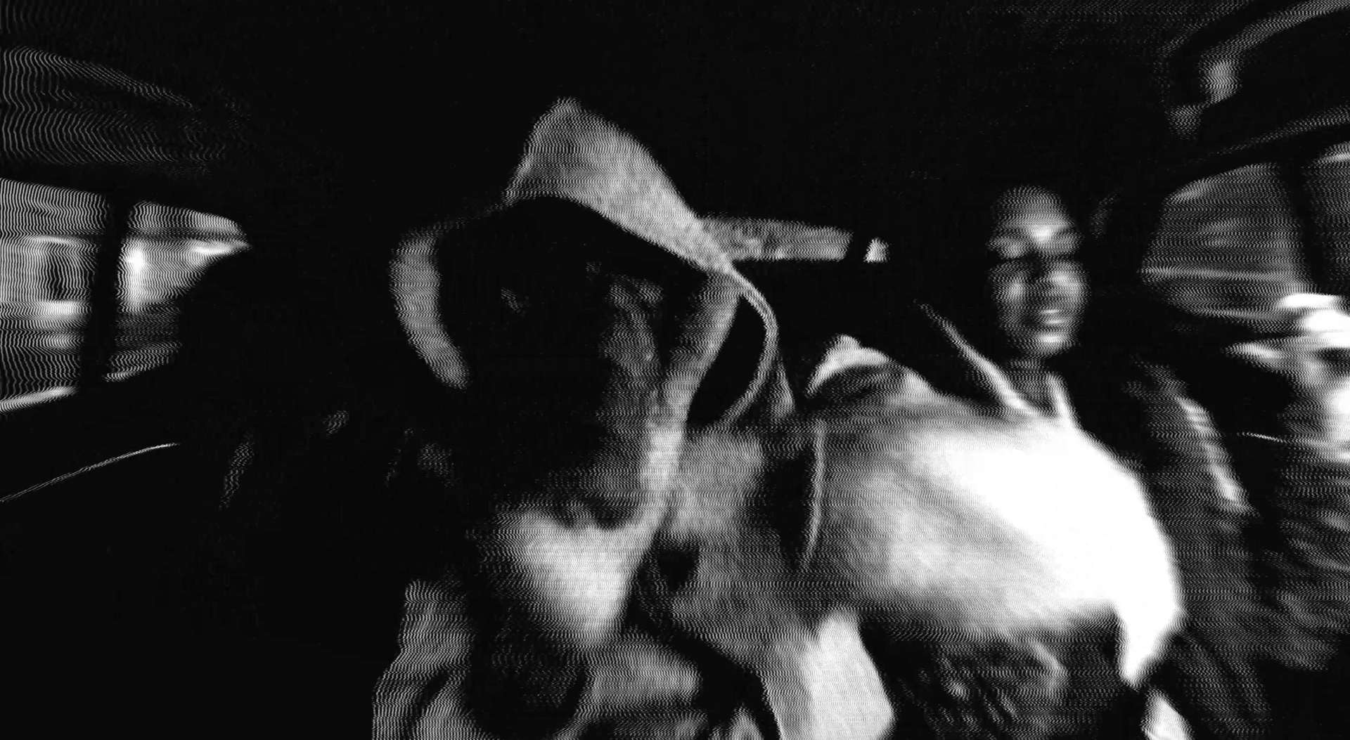 A black and white photo of two people in a car.