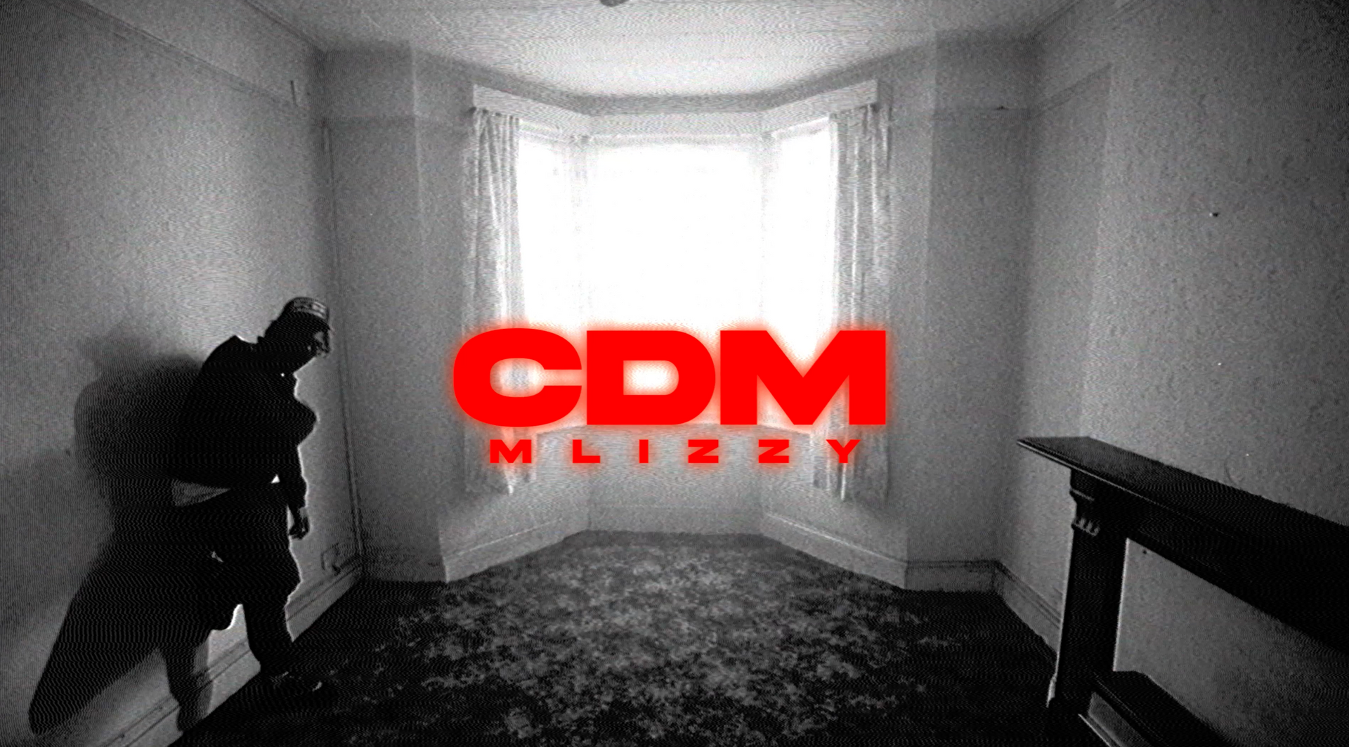 A man is standing in an empty room with a window.