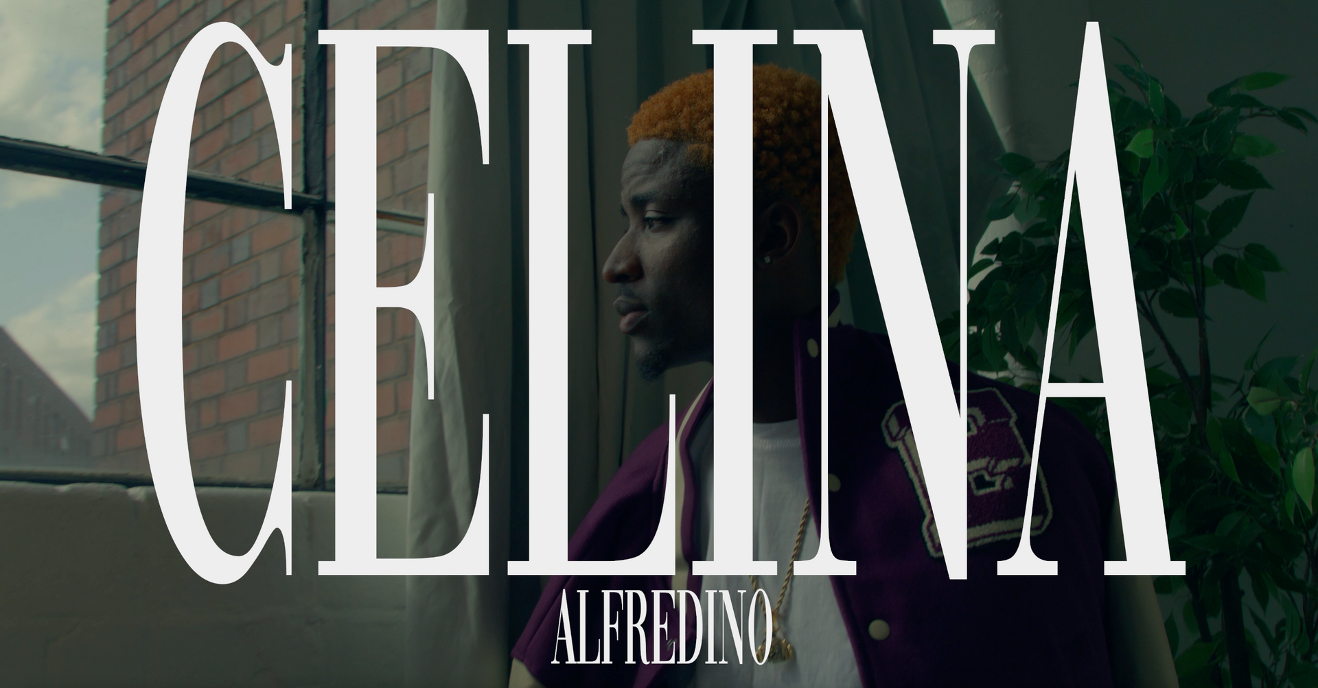 A man standing in front of a window with the word celina on it