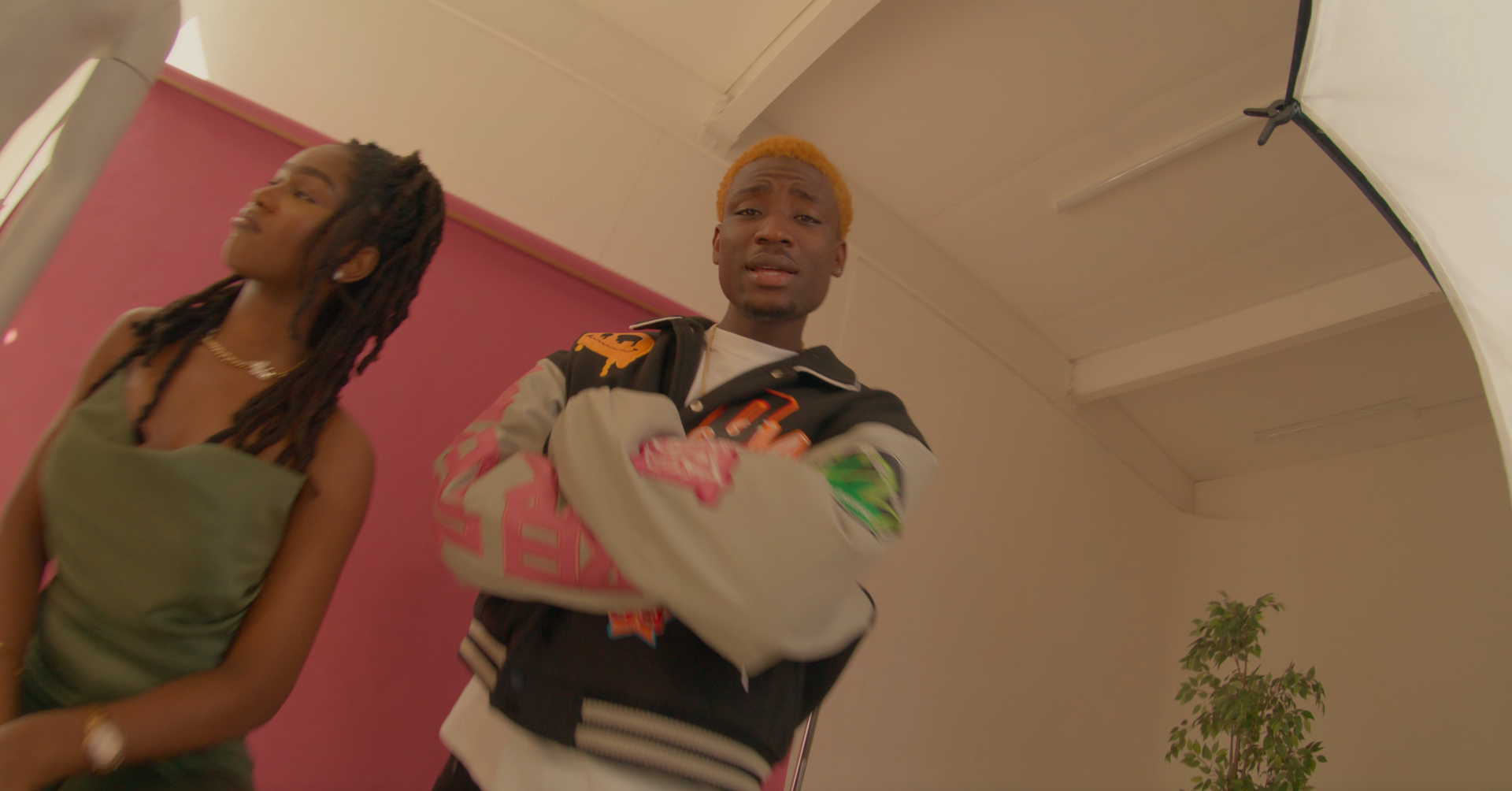 A man and a woman are standing next to each other in a room.