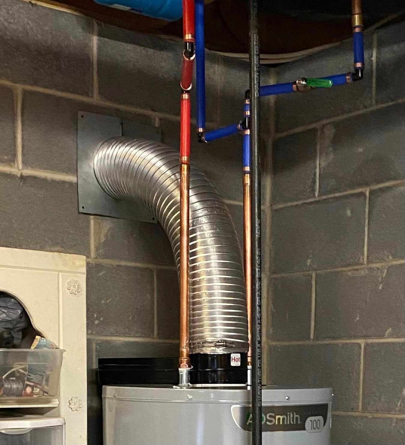 A Water Heater with A Hose Attached to It - Bristol, TN - Austin’s Plumbing, LLC