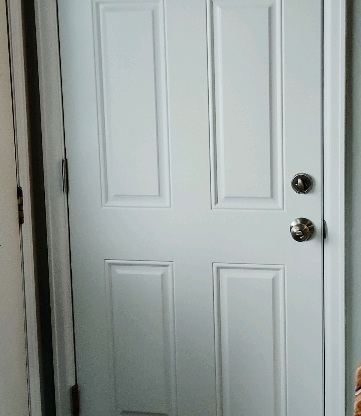 A white door with a gold knob on it