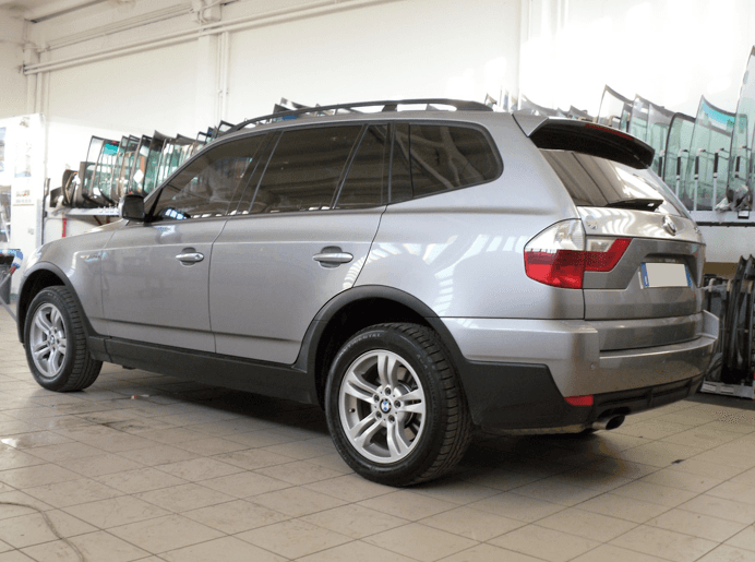 SUV BMW X3 argentato parcheggiato in un garage.